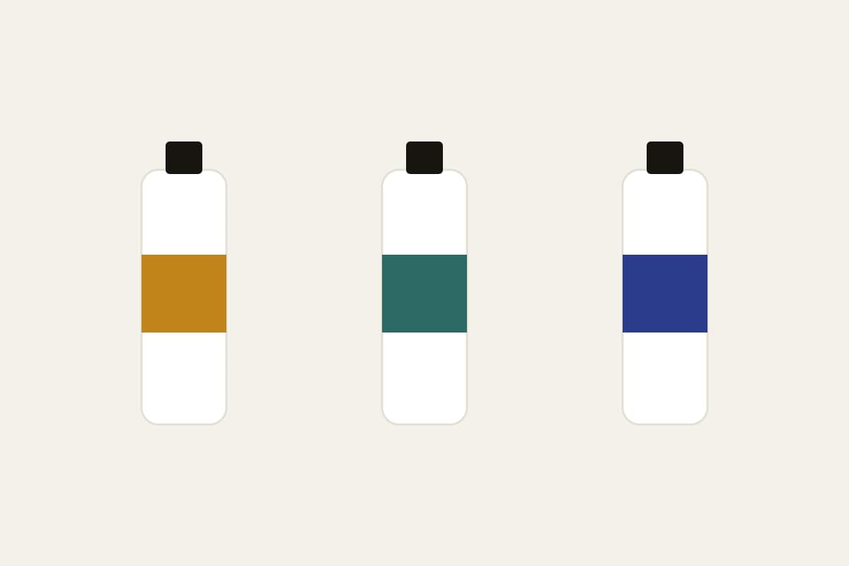 Three MARK bottles with amber, teal and indigo label bands